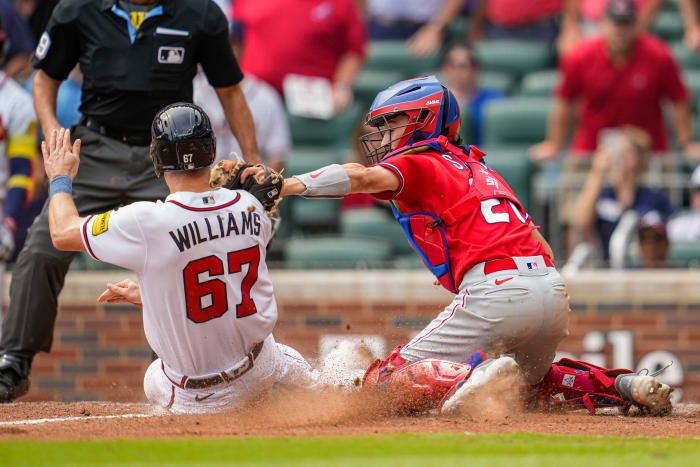 Sep 20, 2023; Cumberland, Georgia, USA; Philadelphia Phillies catcher Garrett Stubbs (21) tags out Atlanta Braves pinch runner Luke Williams (67) preventing the game winning run during the ninth inning at Truist Park.